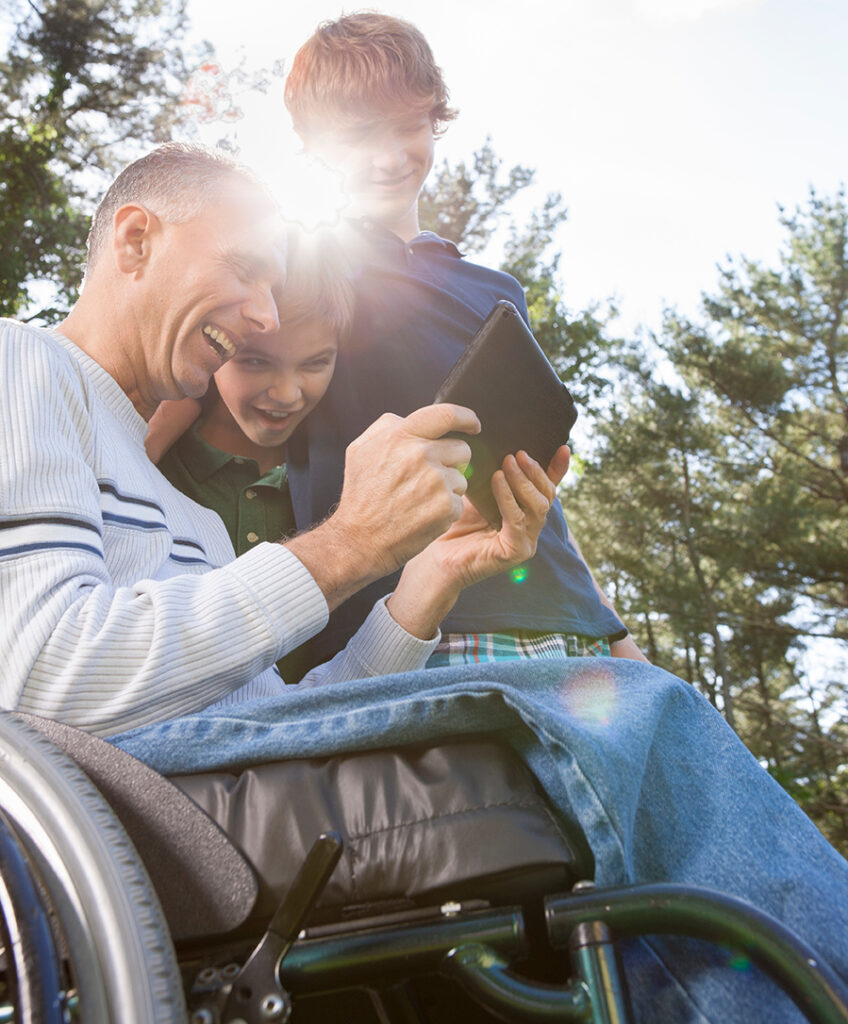 man with kids in wheelchair